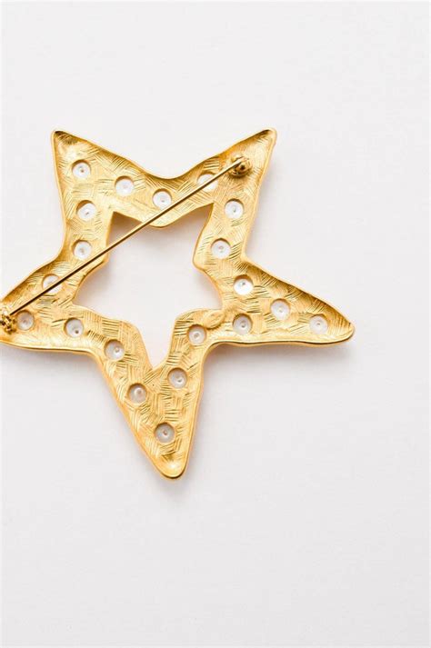 givenchy star brooch|Givenchy brooch.